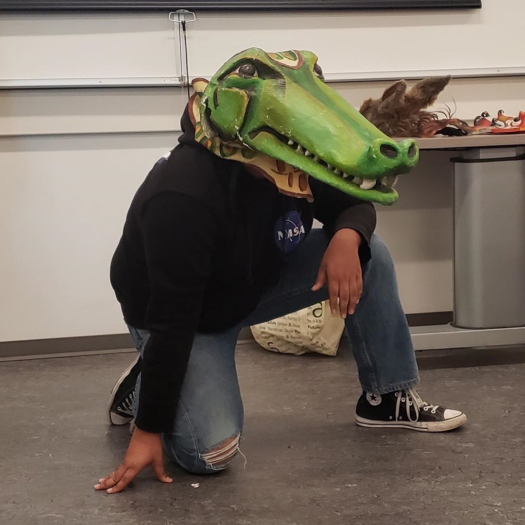 Image of a student playing a crocodile in the Shakespeare mask workshop