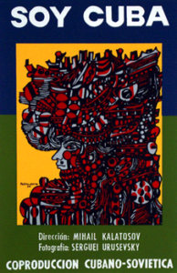 Blue, green, yellow, and red colored film poster image with an abstract human face with headdress and text in white: Soy Cuba Dirección MIHAIL KALATOSIV Fotographia SERGUEI URUSEVSKY COPRODUCCION CUBANO-SOVIETICA