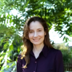 Amalia Herrmann headshot in front of green leaves